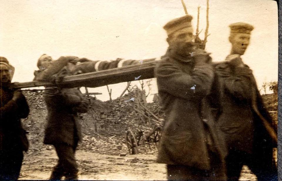 Photo Album, page 03: German prisoners carrying British wounded, Mametz Village, France. 