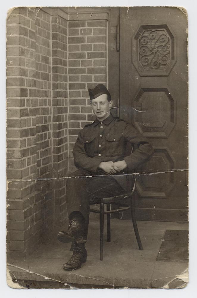 Pte. William McLeish in uniform, sitting, taken at German P.O.W. Camp Rennbahn, 1916, WWI