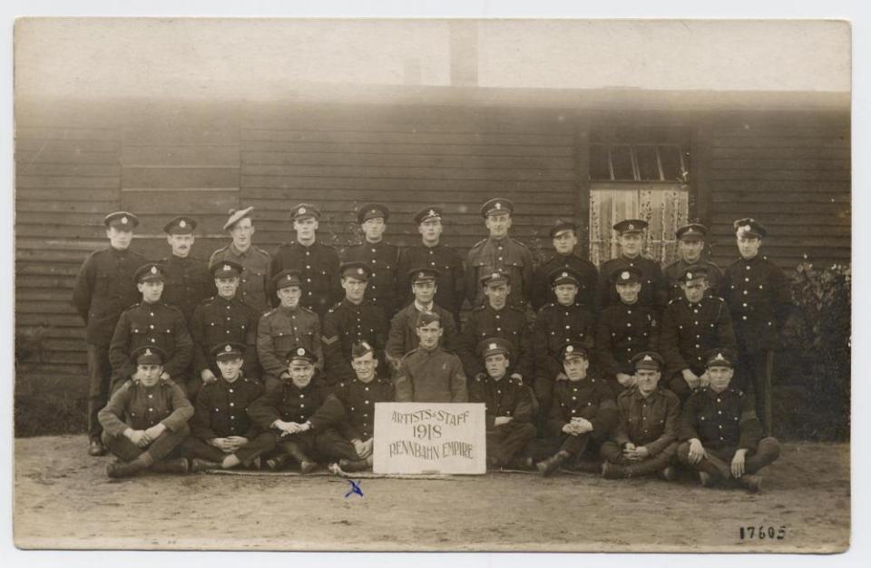 P.O.W. soldiers & sign “Artists & Staff 1918 Rennbahn Empire” William McLeish in front row. WWI